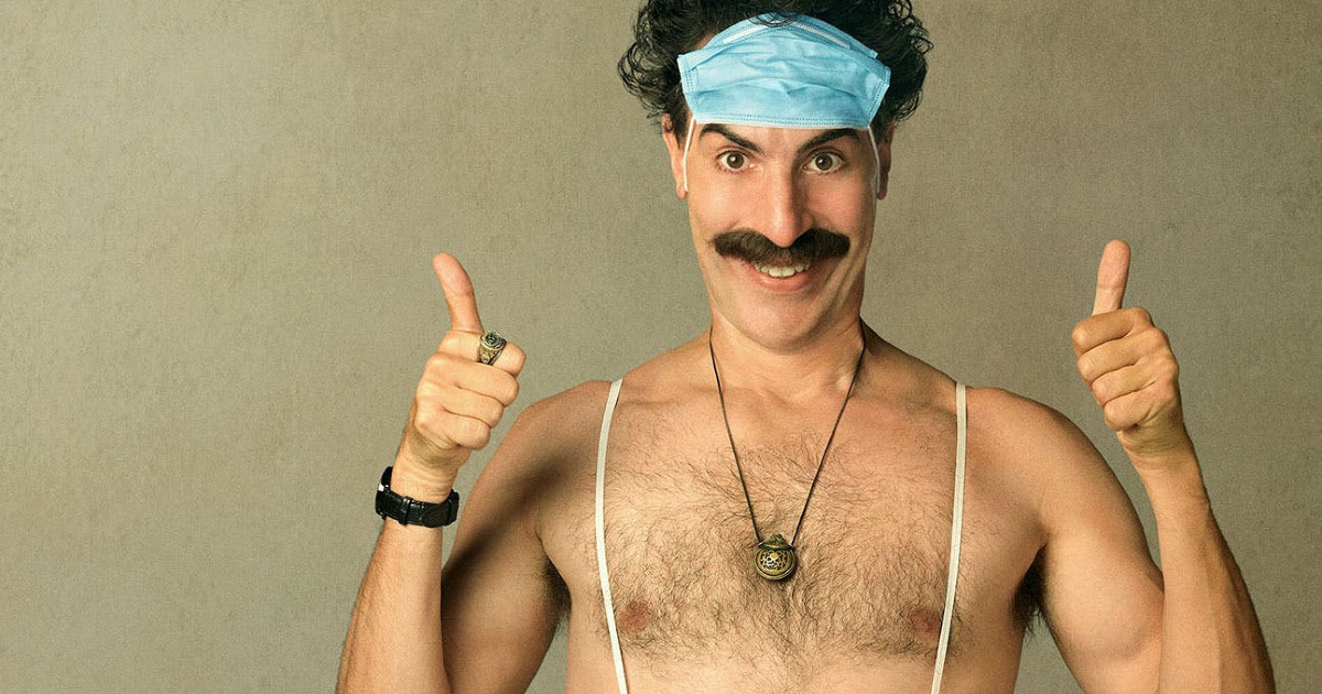 borat a petto nudo da due ok coi pollici e indossa una mascherina sulla fronte - nerdface