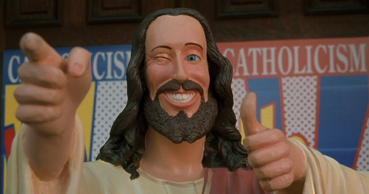 il cristo compagnone di dogma, satira su chi lucra intorno alla religione, è raffigurato in una statua che strizza l'occhio e fa l'ok nel film di kevin smith - nerdface