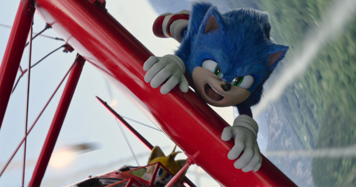 sonic è aggrappato all'ala rossa di un biplano in volo - nerdface