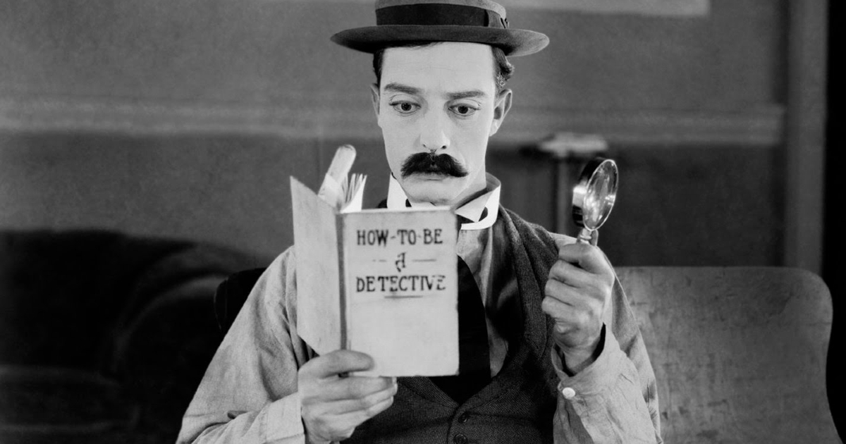 buster keaton ha i baffi finti e legge un libro su come diventare detective - nerdface