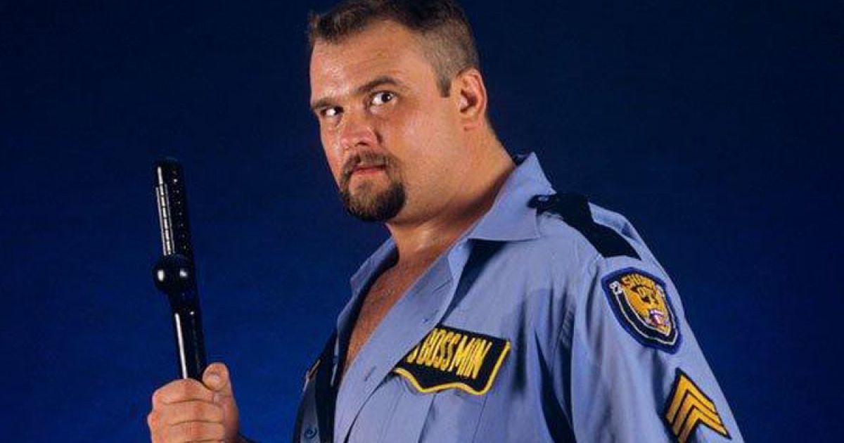 big boss man in divisa da poliziotto e col manganello in mano è pronto per una royal rumble - nerdface