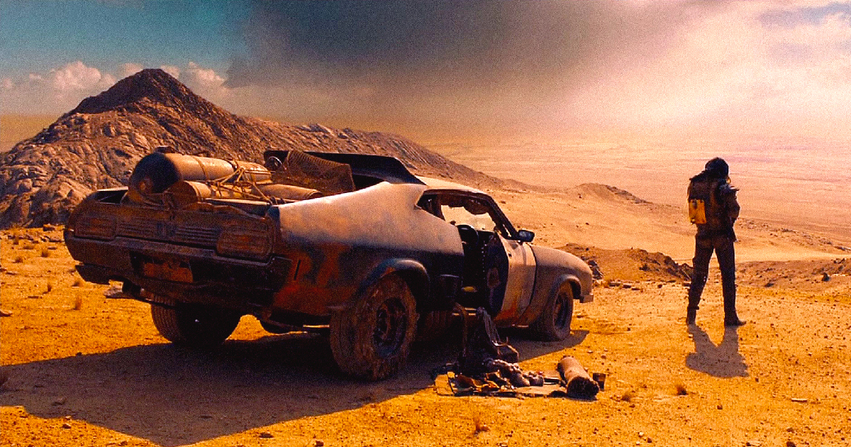 mad max accanto alla sua interceptor in fury road - nerdface